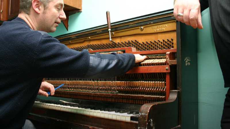 A piano tuner, tags: moving pianos fragile - CC BY-SA